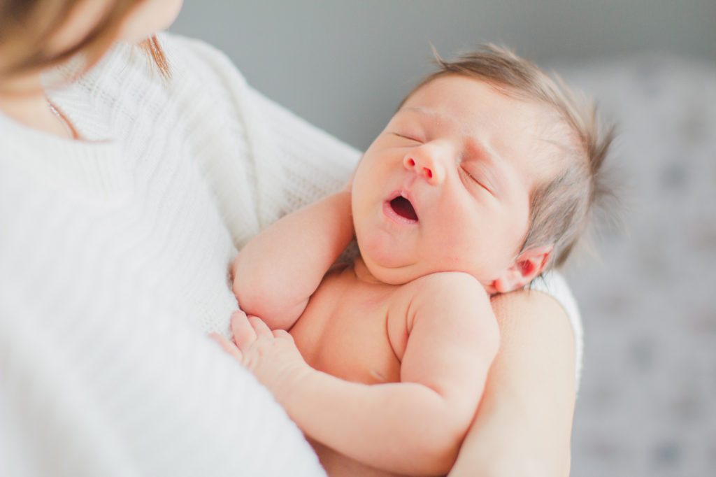 Ewing Newborn Session, Melissa Storey Photography, Mom holding newborn in her arms, newborn sleeping peacefully