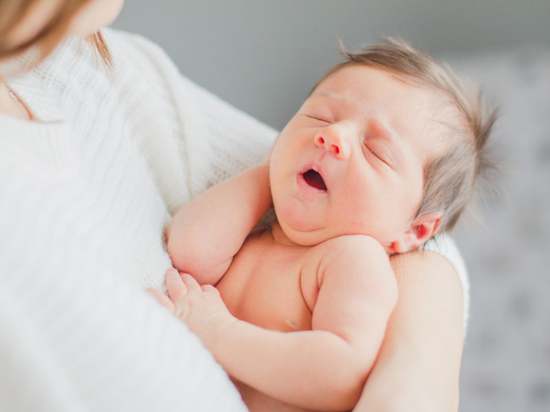 Ewing Newborn Session, Melissa Storey Photography, Mom holding newborn in her arms, newborn sleeping peacefully