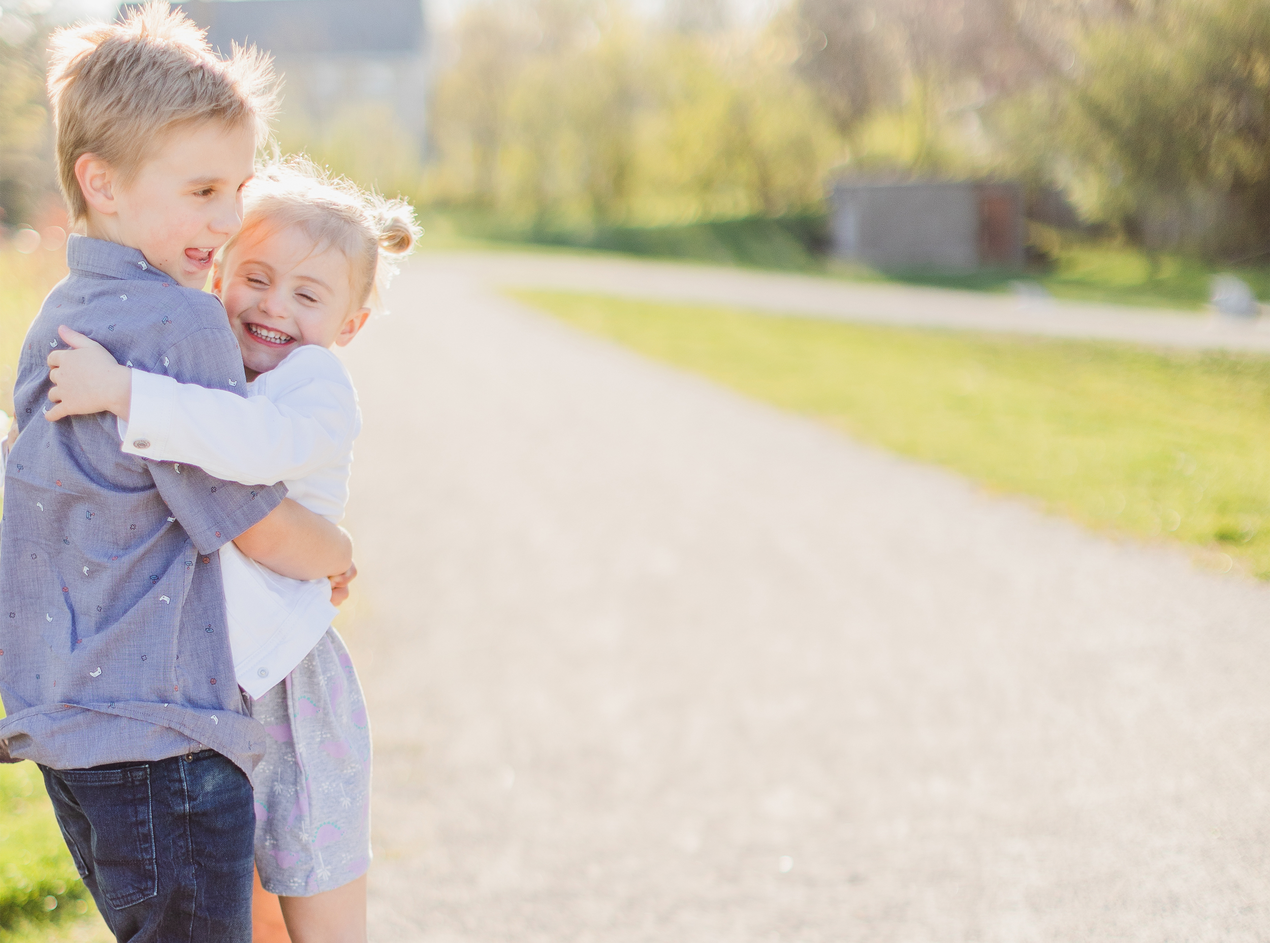 Wheaton Illinois, Northside Park. Siblings hugging and laughing with each other