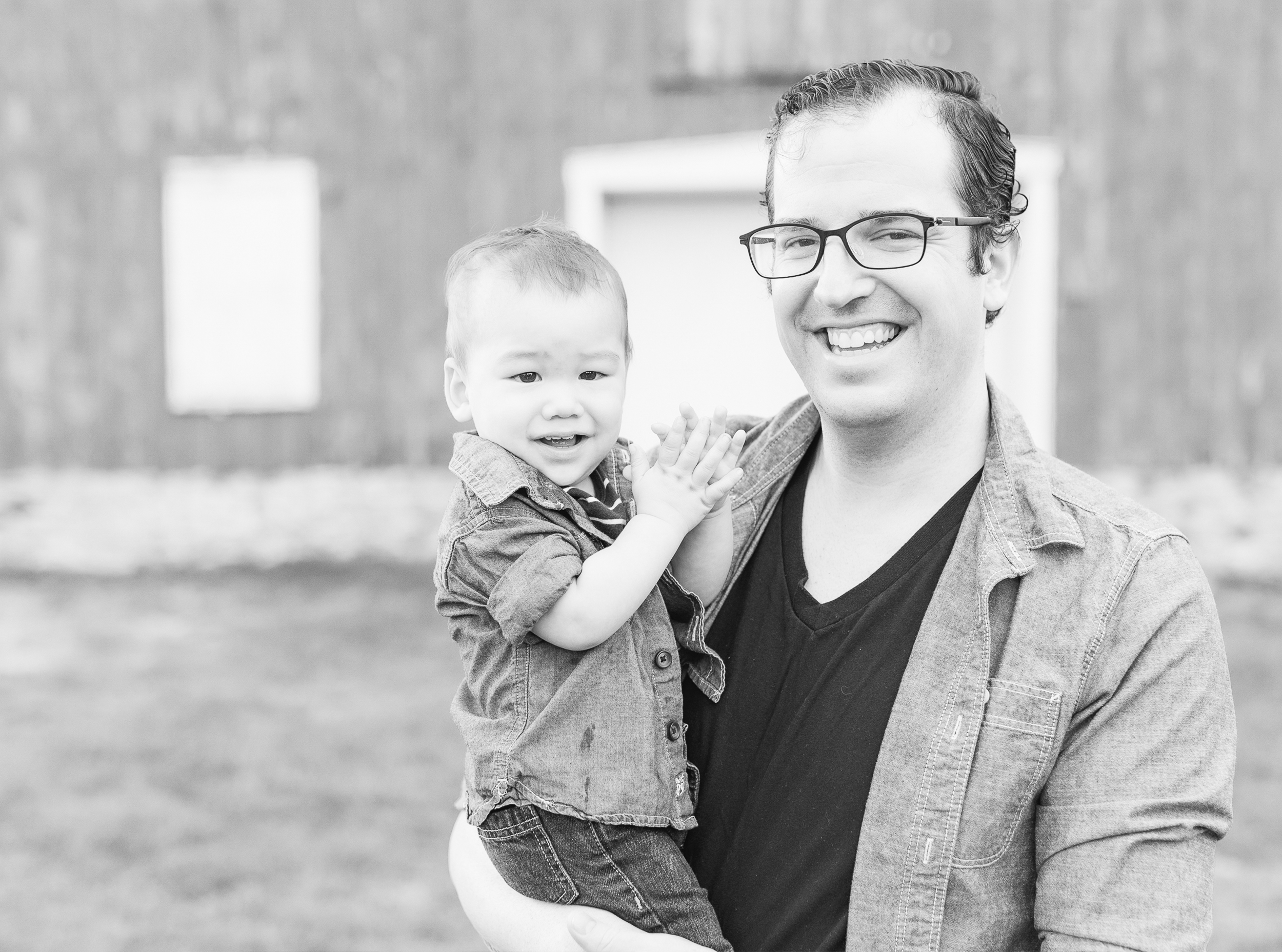 St. Charles, IL. LeRoy Oaks Forest Preserve. Dad is holding son, both smiling into the camera