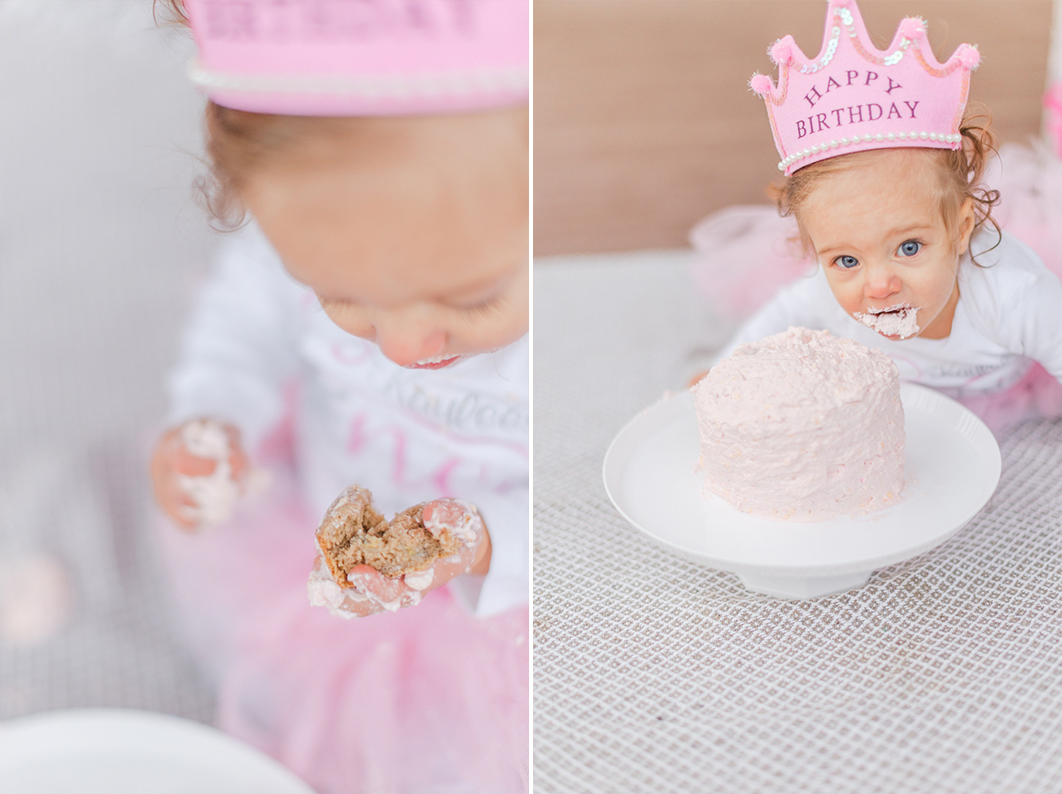 One year old is digging into her first birthday cake.