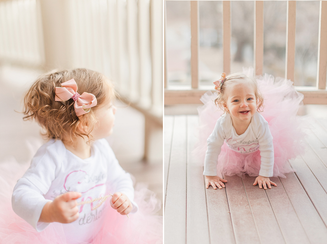 One year old girl wears a pink tutu and crawls towards the camera