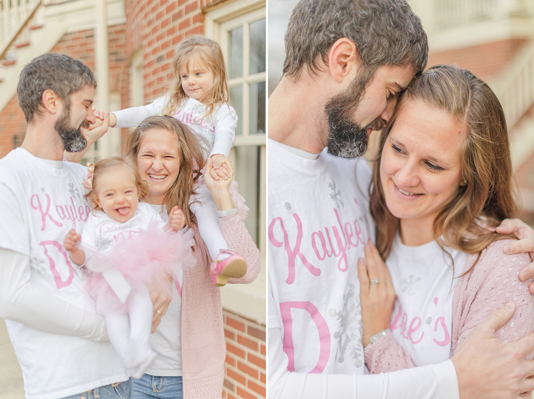 Family Session for first birthday. Dad is hugging mom, who is smiling over his shoulder