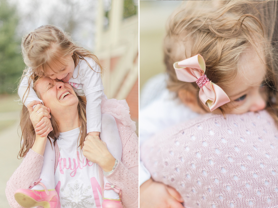 Mom is carrying her daughter on her shoulders laughing at each other