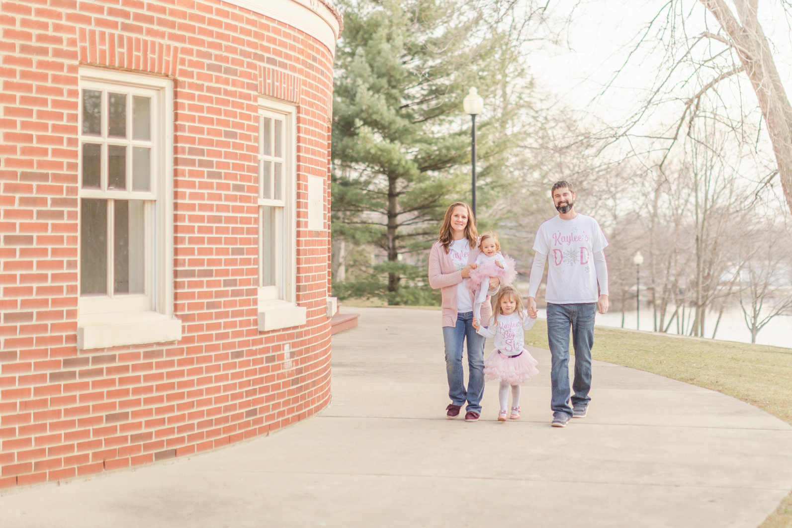 Family photo during First Birthday Session. Family is walking towards the camera