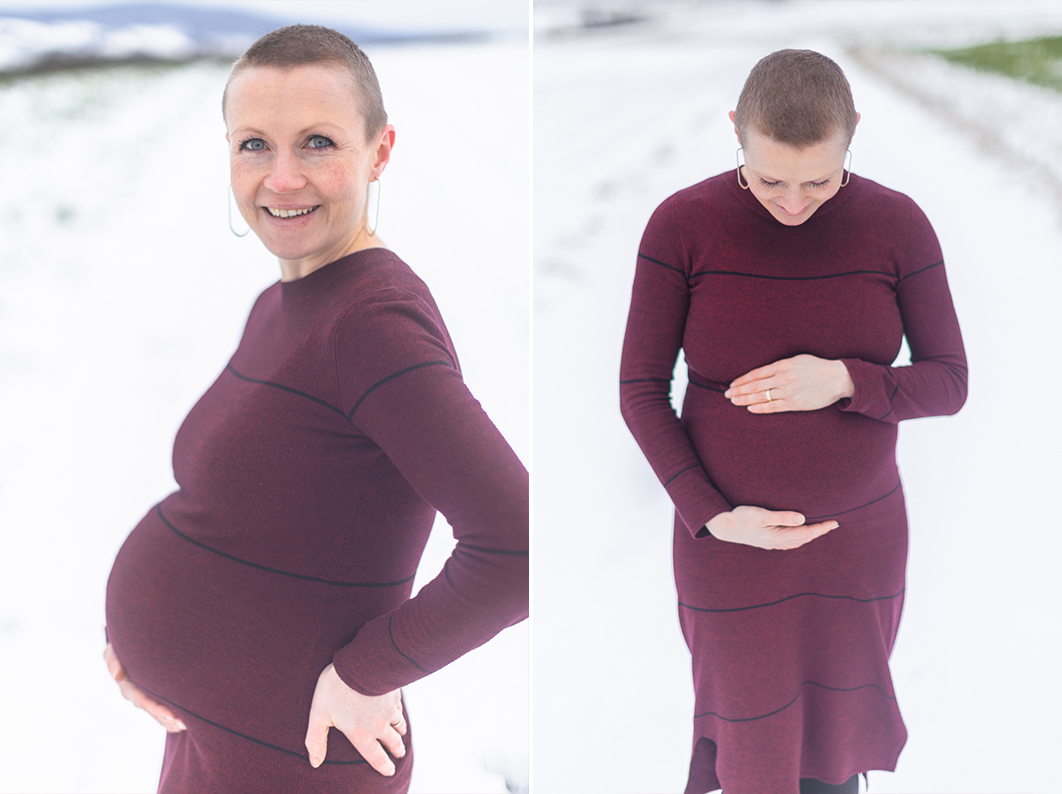 Winter Maternity session in Germany. Mother is holding her bally, smiling down at it.