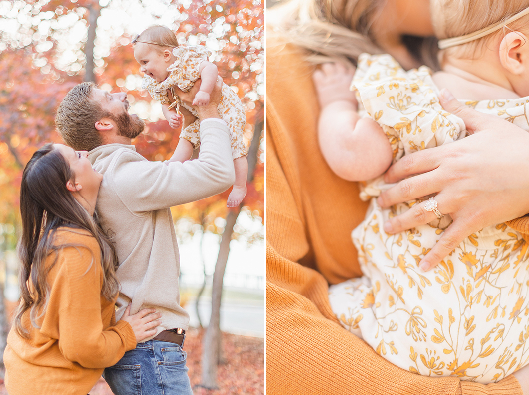 fall family mini session. Parents are standing in front of red leaves fall trees, Dad is throwing daughter in the air, who is laughing back at mom and dad