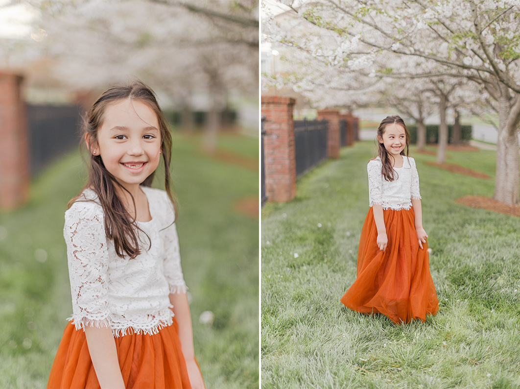 Portrait of daughter , swinging her dress and smiling into the camera during their charlotte spring minis.